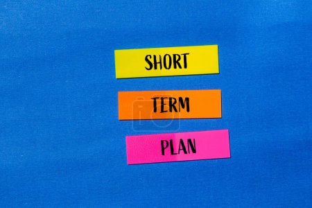 Short term plan words written on colorful stickers with blue bac