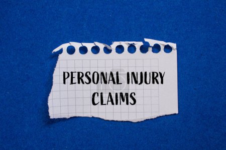 Photo for Personal injury claims written on ripped white paper with blue b - Royalty Free Image
