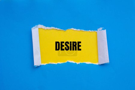 Desire word written on ripped blue paper with yellow background