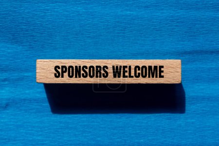 Sponsors welcome words written on wooden block with blue background. Conceptual business symbol. Copy space.