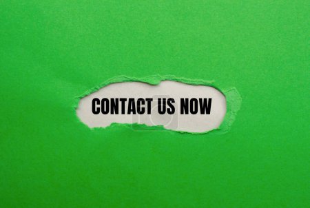 Contact us now words written on ripped green paper with gray background. Conceptual contact us now symbol. Copy space.