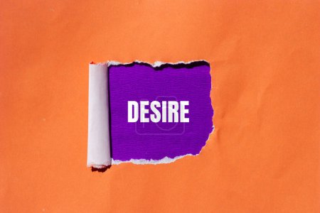 Desire word written on ripped orange paper with purple background