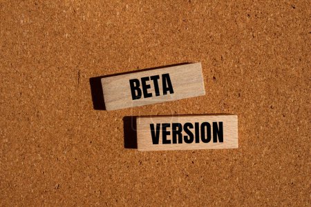 Beta version words written on wooden blocks with brown background. Conceptual beta version symbol. Copy space.