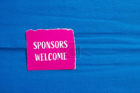 Sponsors welcome words written on ripped pink paper piece with blue background. Conceptual business symbol. Copy space.