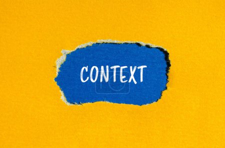 Context word written on ripped yellow paper with blue background. Conceptual context symbol. Copy space.
