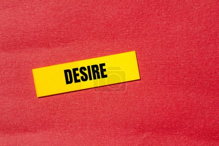Desire word written on yellow sticker with red background