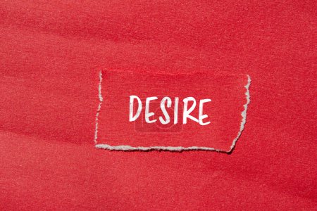 Desire word written on ripped red paper with red background