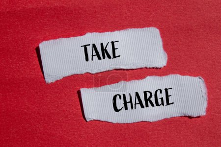 Take charge words written on ripped white paper pieces with red background. Conceptual take charge symbol. Copy space.