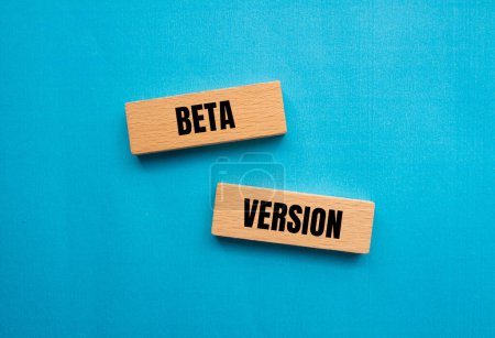 Beta version words written on wooden blocks with blue background. Conceptual beta version symbol. Copy space.