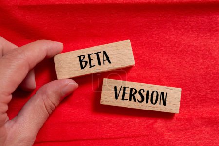 Beta version words written on wooden blocks with red background. Conceptual beta version symbol. Copy space.