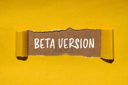 Beta version words written on ripped yellow paper with brown background. Conceptual beta version symbol. Copy space.