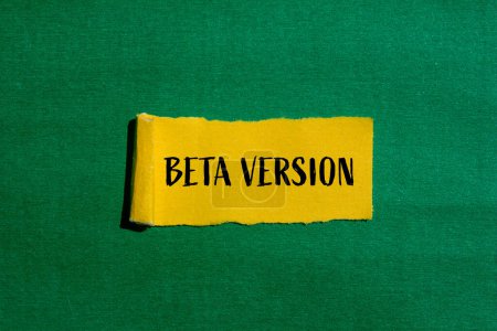 Beta version words written on ripped yellow paper with green background. Conceptual beta version symbol. Copy space.