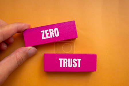 Photo for Zero trust words written on wooden pink blocks with orange background. Conceptual zero trust symbol. Copy space. - Royalty Free Image