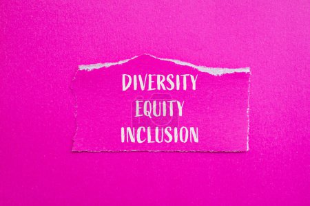 Diversity, equity and inclusion words written on ripped paper with pink background. Conceptual diversity, equity and inclusion DEI symbol. Copy space.