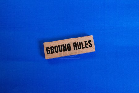 Ground rules message written on wooden block with blue background. Conceptual ground rules symbol. Copy space.