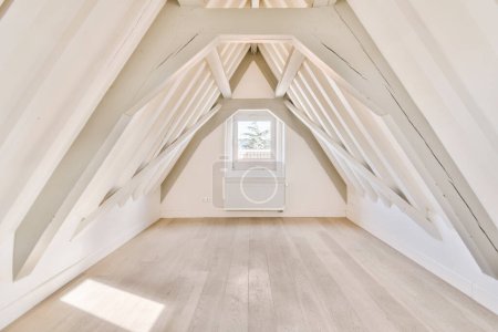 Photo for An attic room with white walls and wooden floors, all painted in the same color as natural wood flooring - Royalty Free Image