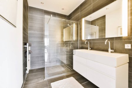 Foto de Un moderno cuarto de baño con azulejos en blanco y negro en las paredes, junto con un paseo en la puerta del puesto de ducha - Imagen libre de derechos