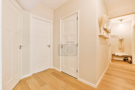 Photo for An empty room with wooden floors and white doors in the middle part of the room there is a mirror on the wall - Royalty Free Image