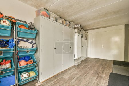 Photo for The inside of a room that is being used as a storage for clothing and other items, including shoes and bags - Royalty Free Image