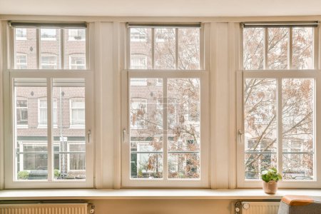 Photo for Some windows in a house that has been painted white and the window panes are covered with frosty glass - Royalty Free Image