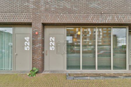 Photo for Amsterdam, Netherlands - 10 April, 2021: a brick building with two doors on each side and one door open to the other, in front of it - Royalty Free Image
