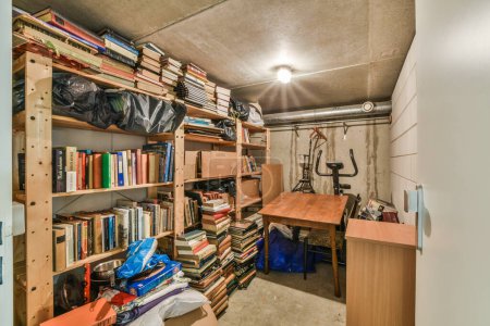 Photo for A room with many books on the shelves and an open door leading to another room that is full of stuff - Royalty Free Image
