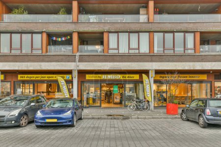 Photo for Amsterdam, Netherlands - 10 April, 2021: two cars parked in front of a building with an advertisement on the side of the building that says i love you - Royalty Free Image