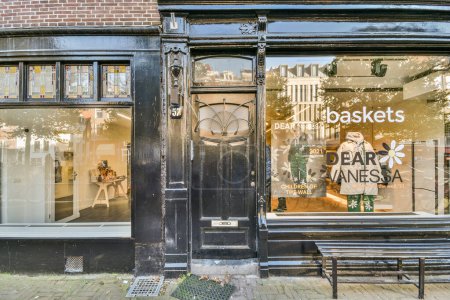Photo for Amsterdam, Netherlands - 10 April, 2021: a store window with a clock on the front and an advertisement in the window that says basis cafe - Royalty Free Image
