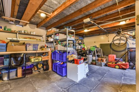 Photo for Amsterdam, Netherlands - 10 April, 2021: the inside of a garage with tools and boxes on the floor to be used for work or other things that are not in use - Royalty Free Image