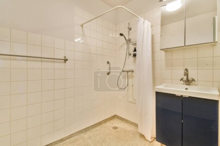 Photo for A bathroom with a sink, mirror, and shower stall in the same color as it appears on the wall - Royalty Free Image