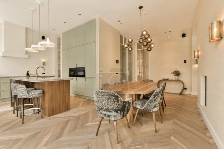 a kitchen and dining area in a modern style apartment with wood flooring, white walls and light green cabinets