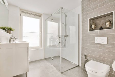 Photo for A bathroom with a toilet, sink and shower stall in the corners on the left side of the room - Royalty Free Image
