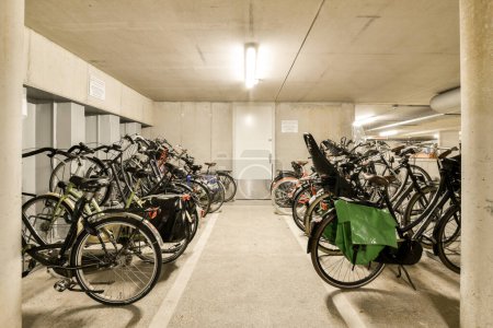 Photo for Several bikes parked in a parking space with no one on the ground, and there is an open area for them to use - Royalty Free Image