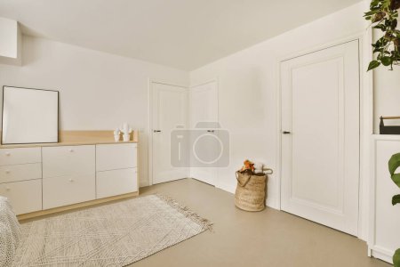Photo for A bedroom with white closets and large plant in the corner on the right hand side of the room is an entryway to - Royalty Free Image
