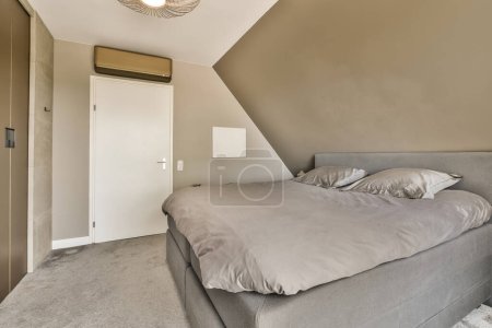 Photo for A bedroom with a bed and closets in the back wall, there is a ceiling light hanging above the bed - Royalty Free Image