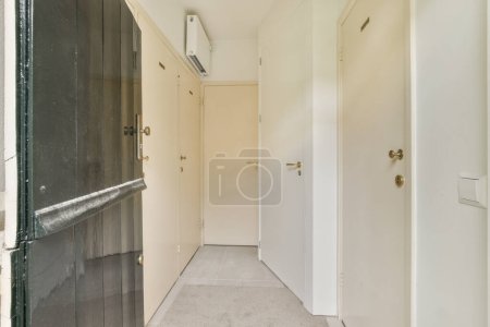 Photo for An empty hallway with no people or objects on the wall and door to the left, there is only one person in the room - Royalty Free Image