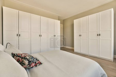 Photo for A bedroom with white closets and wood flooring in the master suite at seaview villas, a self - friendly holiday rental - Royalty Free Image