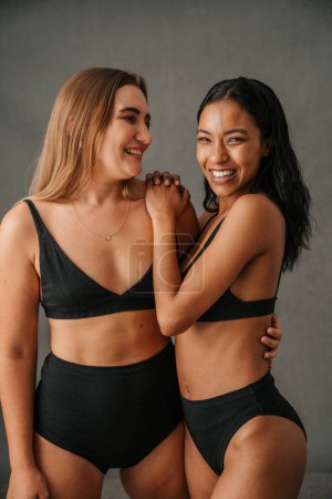 Photo for Portrait of two fun loving diverse girlfriends posing in the studio. High quality photo - Royalty Free Image