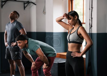Photo for The group is working out in the gym, focusing on exercises for arms, legs, chests, and thighs. They are wearing shorts, undershirts, and making gestures to work their muscles and waist - Royalty Free Image