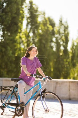 Photo for Latin rider female rider outside for environment sustainability with copy space - Royalty Free Image