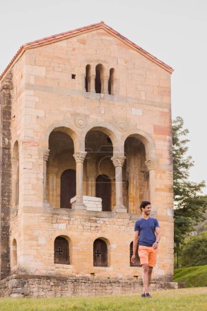 Photo for Tourist lifestyle person in summer. Oviedo Santa Maria del Naranco, pre-romanesque world heritage historic building. - Royalty Free Image
