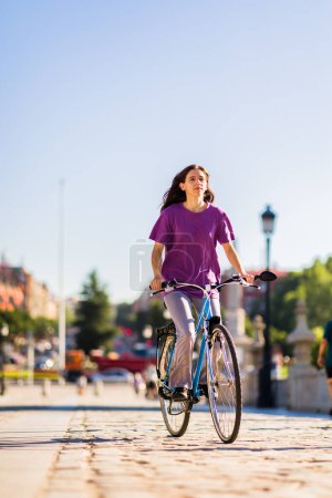 Photo for Outdoors transport cyclist for eco friendly mobility. leisure and recreation from a south american woman - Royalty Free Image