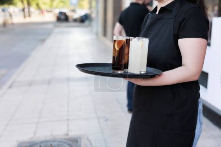 Photo for Serving food and drinks in a bar. Hispanic service person occupation - Royalty Free Image