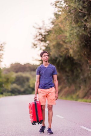 Photo for Male 40s travel with baggage alone and sad on a road. modern tourist traveler abroad. risk relationship adventure - Royalty Free Image