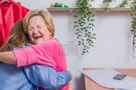 Photo for Positive portrait from success entrepreneur and pensioner mother laugh and embrace. pensioner insurance and retirement concept. - Royalty Free Image