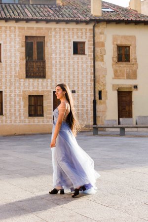 Photo for Success and achievement bachelor degree. Happiness portrait in Salamanca Campus with long dress and graduation stole. One person in Europe, Spain - Royalty Free Image