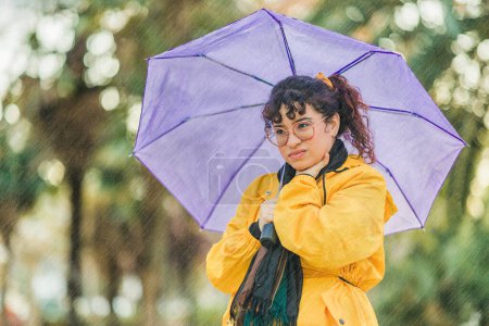 Photo for Hispanic woman outdoor in winter waterproof clothes. Rain and wet climate outdoor. medical health illness. Influenza disease health care - Royalty Free Image