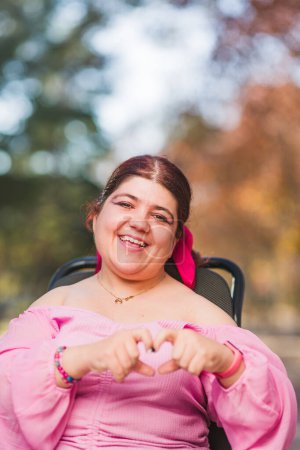Photo for International womens day feminist movement with empowered diverse person with disability on a wheelchair, smile for authentic identity. Social inclusion and romantic concept - Royalty Free Image