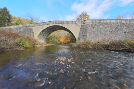 Photo for Beautiful fall color surrounding the Casselman River Bridge in Garrett County Maryland - Royalty Free Image