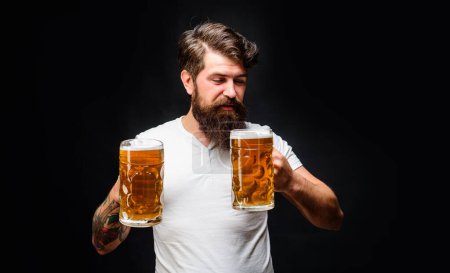 Photo for Satisfed man with two mugs of beer. Alcohol. Bar, pub or restaurant advertising. Handsome man enjoying cold pint of beer. Brewing. Beer time. Oktoberfest celebration. Bearded man tasting draft beer - Royalty Free Image